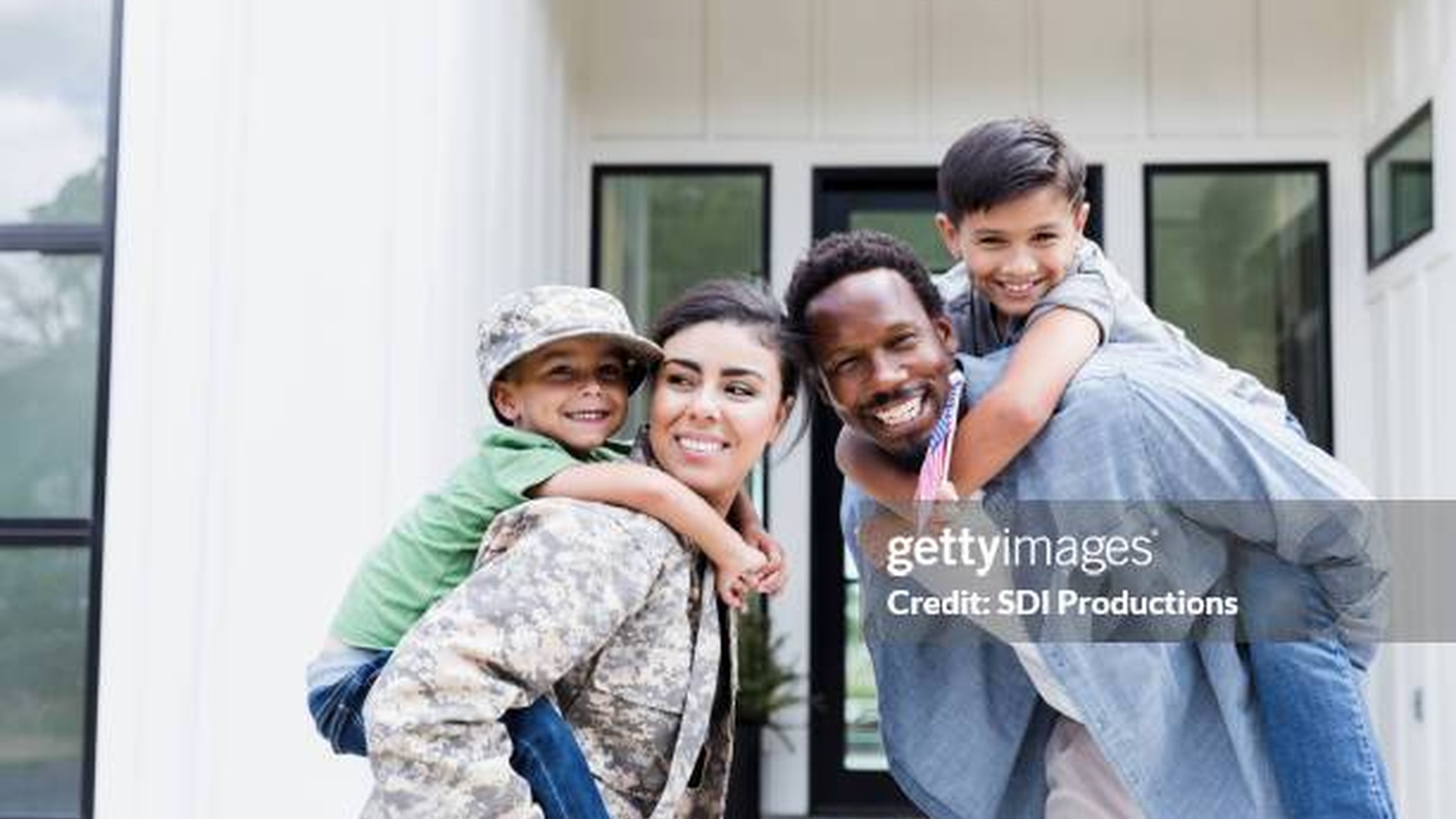 Alabama military family standing in front of their home