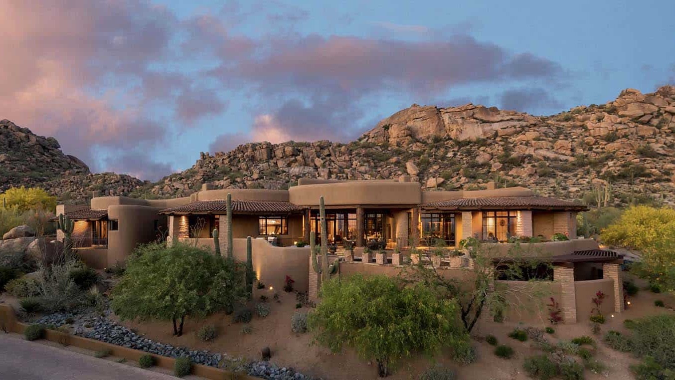 Southwest adobe style home with desert landscaping in Arizona