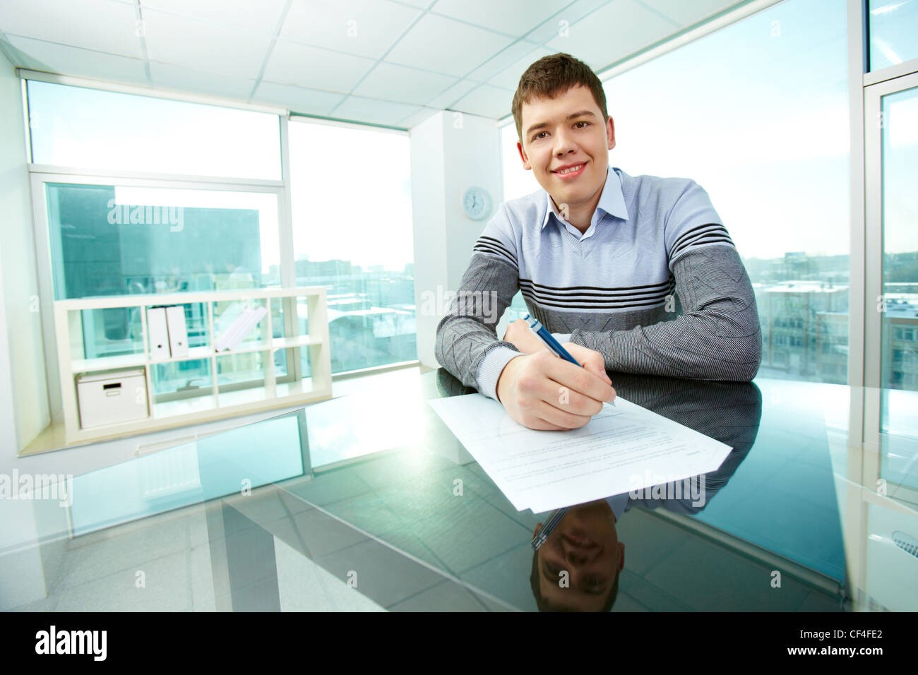 Happy person signing loan documents
