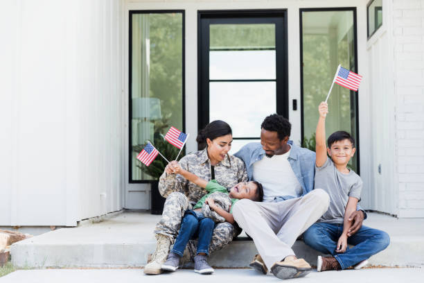 Military family in front of their new home