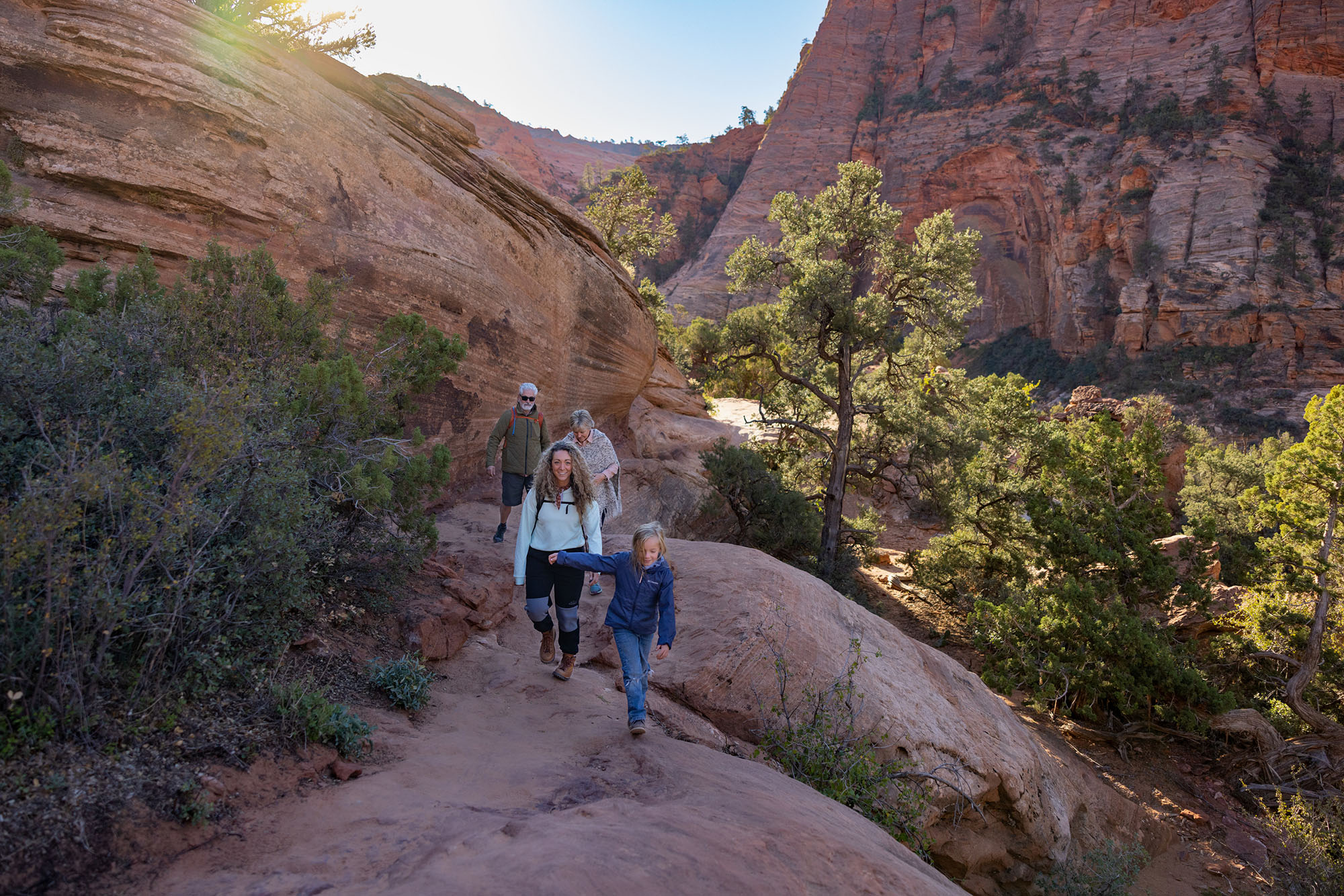 Family hiking in Utah mountains enjoying outdoor lifestyle
