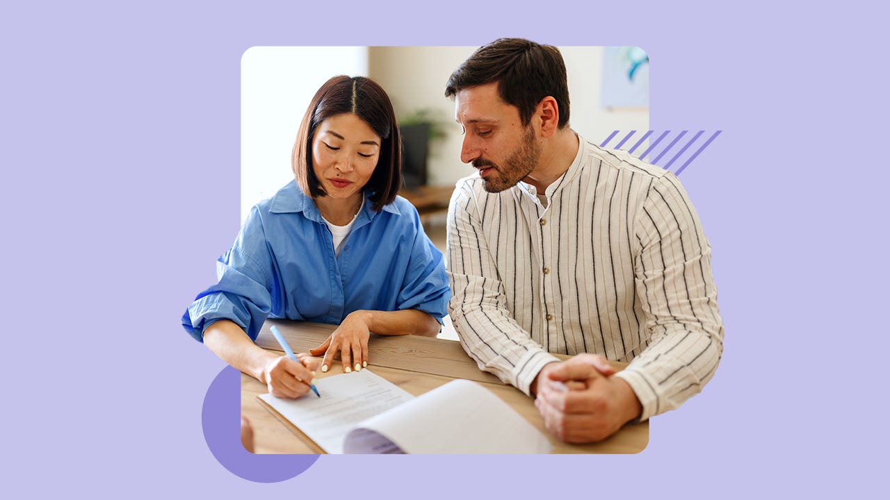Utah couple reviewing conventional loan documents with their mortgage professional