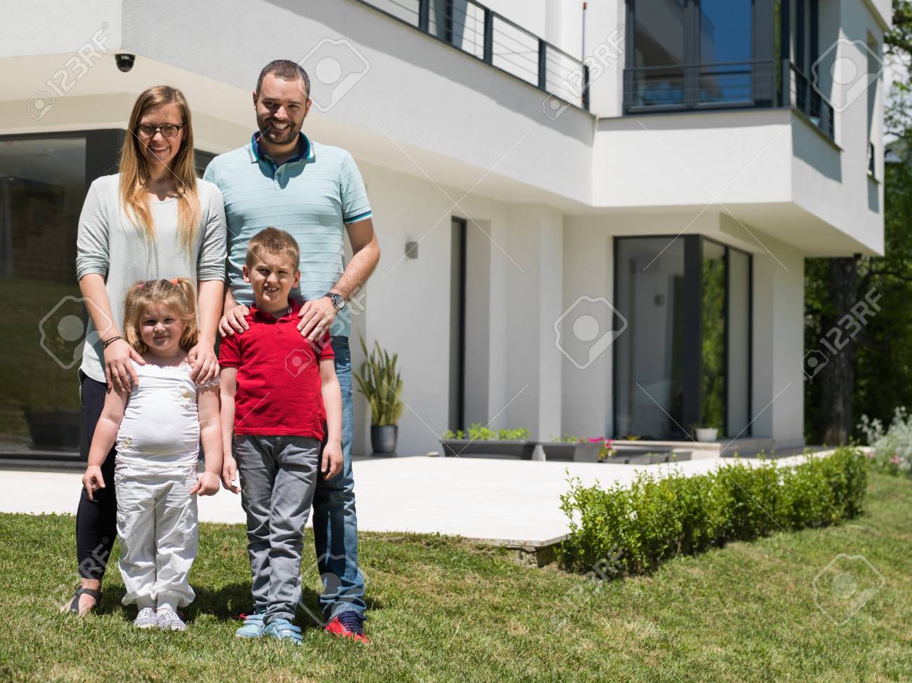 Utah family in front of their luxury home purchased with jumbo loan financing