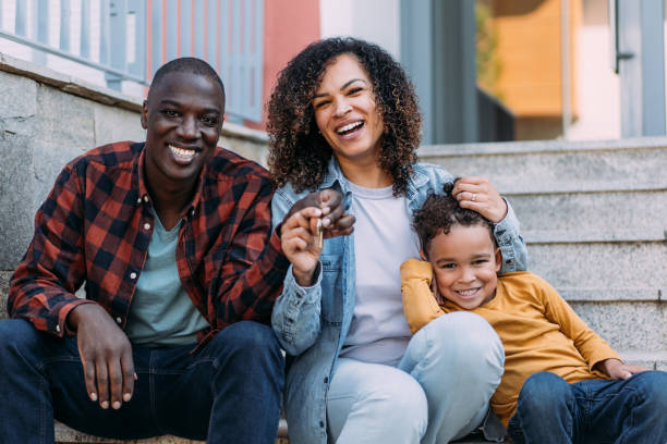 Happy Utah family celebrating mortgage pre-approval with keys to their new home